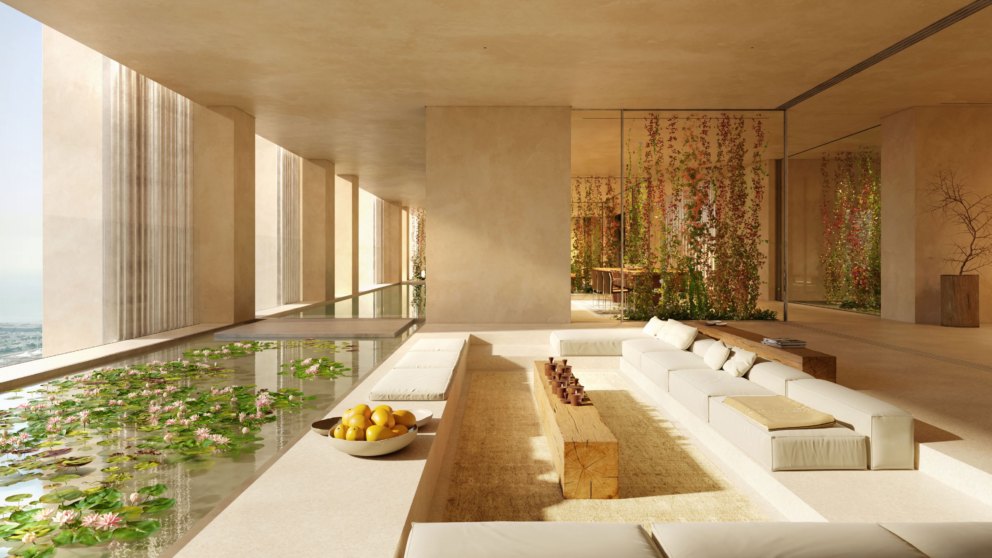 Sunlit living room with sunken sofas beside a lily pond and pool