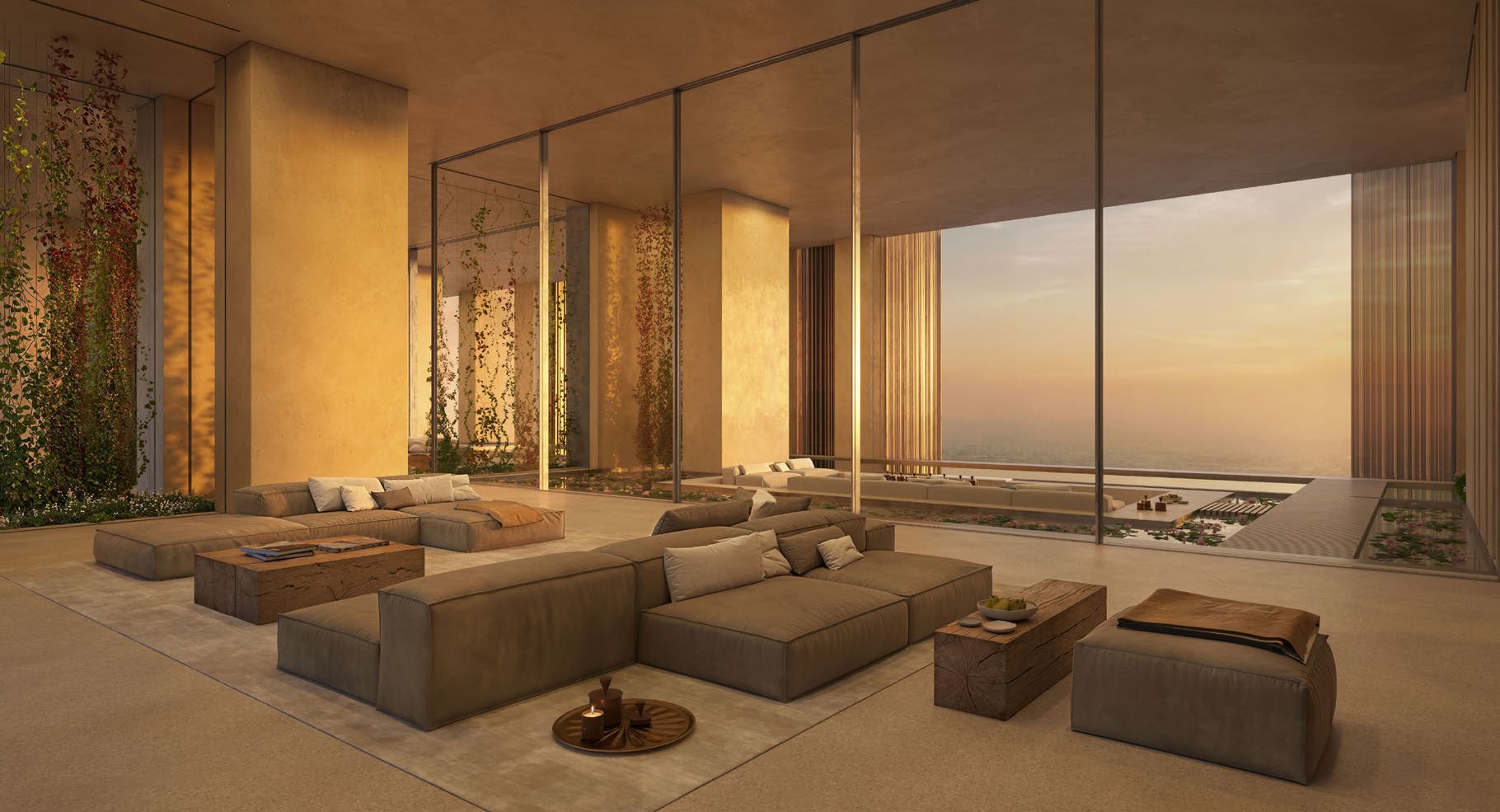 Spacious living room with deep sofas and sunset views through glass